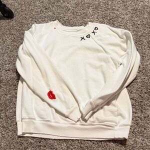 distressed XOXO embroidered sweatshirt